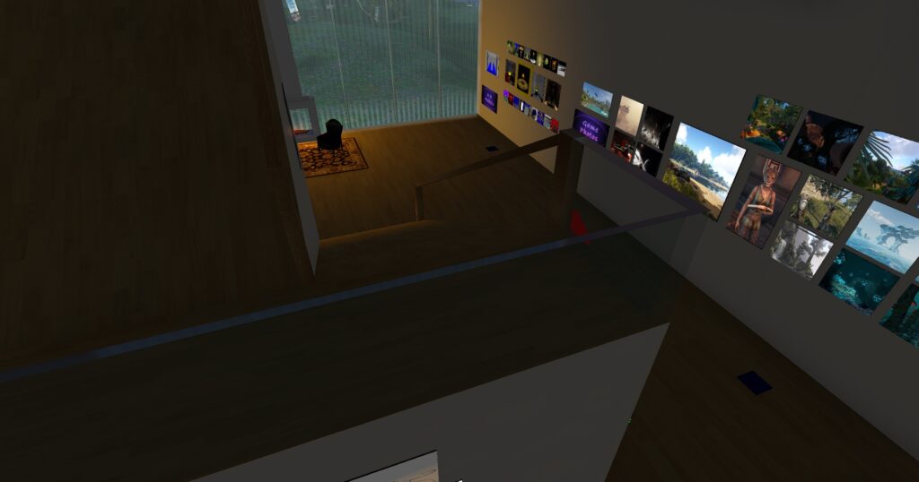 View inside the Virtual Ability art gallery showing the ramps to the second floor and a wall of images from games and 3D model images.