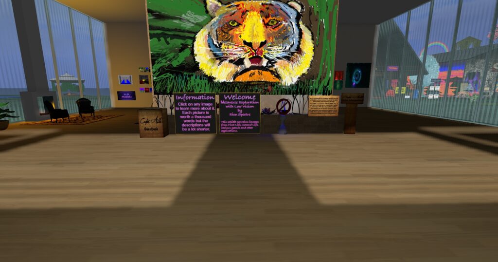Just inside the Virtual Ability art gallery lobby. A somewhat abstract rainbow colored tiger painting is clearly visible as well as informational signs and an object which states that none of this art was created with artificial intelligence.
