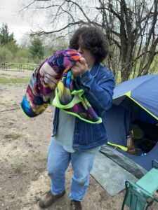 Photograph of Itico's author with a borrowed blanket outside his tent.